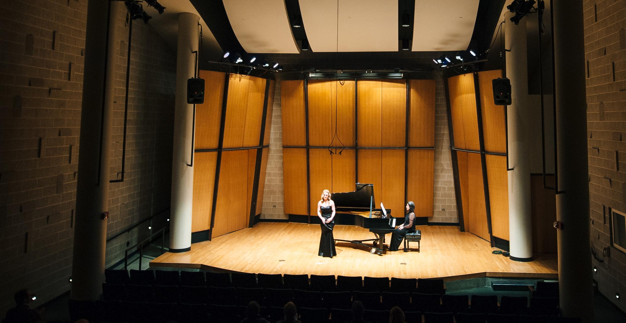 Singer and pianist performing in recital hall